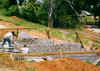 Foundation walls with steel reinforcing run vertically and horizontally with the block concrete filled walls.